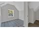 Bright bedroom with an eye-catching starburst patterned tile floor and large window letting in natural light at 116 Tallapoosa St, Temple, GA 30179