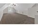 Large bonus room featuring a ceiling fan, dormer window, and plush carpeting at 116 Tallapoosa St, Temple, GA 30179