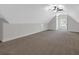 Spacious bonus room featuring a dormer window, wall-to-wall carpeting, and neutral paint palette at 116 Tallapoosa St, Temple, GA 30179