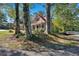 Charming home with a red roof nestled among mature trees at 116 Tallapoosa St, Temple, GA 30179