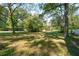 Expansive front yard with mature trees, offering a serene and private outdoor space at 116 Tallapoosa St, Temple, GA 30179