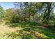 Spacious, level front yard with mature trees, offering a picturesque view of the charming house at 116 Tallapoosa St, Temple, GA 30179
