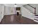 A living room featuring a fireplace, hardwood floors and a staircase at 116 Tallapoosa St, Temple, GA 30179