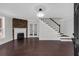 A spacious living room featuring a fireplace, hardwood floors and a staircase at 116 Tallapoosa St, Temple, GA 30179