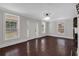 A spacious living room featuring large windows, hardwood floors and a decorative fireplace at 116 Tallapoosa St, Temple, GA 30179