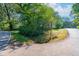 Road view featuring mature trees and lush green surroundings at 116 Tallapoosa St, Temple, GA 30179