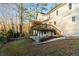 Exterior view of back of house featuring a wooden deck and partially-covered patio at 1190 Midland Way, Lawrenceville, GA 30043