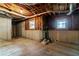 Unfinished basement with exposed beams, concrete floor, and windows at 1190 Midland Way, Lawrenceville, GA 30043