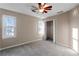 Neutral bedroom with carpeted floor, two windows, and closet at 1190 Midland Way, Lawrenceville, GA 30043