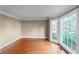 Bright bedroom featuring hardwood floors, large windows, and neutral wall paint at 1190 Midland Way, Lawrenceville, GA 30043
