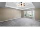 Spacious bedroom with tray ceilings, neutral color palette, and a bay window at 1190 Midland Way, Lawrenceville, GA 30043