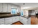 Kitchen featuring white cabinetry, granite countertops, and hardwood floors at 1190 Midland Way, Lawrenceville, GA 30043