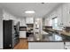 Kitchen featuring updated appliances, granite countertops, hardwood floors, and white cabinetry at 1190 Midland Way, Lawrenceville, GA 30043