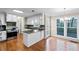 Bright kitchen features a breakfast bar, hardwood floors, and stainless-steel appliances at 1190 Midland Way, Lawrenceville, GA 30043