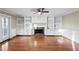 Comfortable living room with built-in shelving, a fireplace, hardwood floors, and a ceiling fan at 1190 Midland Way, Lawrenceville, GA 30043