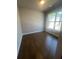 Bright bedroom with hardwood floors and a large window with plenty of natural light at 270 Lakeside Pl, Canton, GA 30114