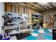 Unfinished basement featuring a workbench and pegboard, as well as a blue and grey tiled floor at 341 Little Pine Ln, Woodstock, GA 30188