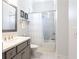Elegant bathroom boasts a tub with shower, sleek vanity, and tiled floor at 341 Little Pine Ln, Woodstock, GA 30188