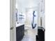 Bathroom featuring a blue vanity, shower with white tile, and nautical accents at 341 Little Pine Ln, Woodstock, GA 30188