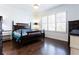 Well-lit bedroom features a four-poster bed, hardwood floors, and ample natural light at 341 Little Pine Ln, Woodstock, GA 30188