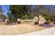 The Longleaf community entrance is marked by a stone monument surrounded by colorful landscaping at 341 Little Pine Ln, Woodstock, GA 30188