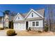 Charming home with gray siding, stone accents, manicured landscaping, and a two-car garage at 341 Little Pine Ln, Woodstock, GA 30188