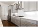 Sleek kitchen featuring stainless steel appliances, custom cabinets, and white countertops at 341 Little Pine Ln, Woodstock, GA 30188