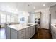 Bright kitchen with large island, stainless steel appliances, and open layout to the dining area at 341 Little Pine Ln, Woodstock, GA 30188