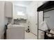 Functional laundry room with modern appliances, custom cabinets, and tiled backsplash at 341 Little Pine Ln, Woodstock, GA 30188