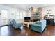 Bright living room features a stone fireplace, hardwood floors, and comfortable seating at 341 Little Pine Ln, Woodstock, GA 30188