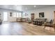 Bright living room featuring a pool table, stylish seating, and hardwood floors at 341 Little Pine Ln, Woodstock, GA 30188