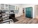A stylish office space featuring modern furnishings, built-in white cabinets and shelving, and beautiful wood-look flooring at 341 Little Pine Ln, Woodstock, GA 30188