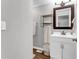Cozy bathroom featuring a vanity with storage, mirror, and stylish shelving at 4481 Mclain Cir, Acworth, GA 30101