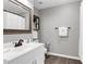Modern bathroom featuring a white vanity, large framed mirror, and dark hardwood floors at 4481 Mclain Cir, Acworth, GA 30101