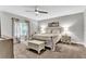 Bedroom featuring a bed, bench, ceiling fan, and neutral decor at 4481 Mclain Cir, Acworth, GA 30101