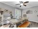 Cozy dining area with a ceiling fan, rustic table, and decor at 4481 Mclain Cir, Acworth, GA 30101