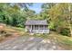 Charming cottage-style home featuring a screened front porch and a lush, wooded lot at 4481 Mclain Cir, Acworth, GA 30101
