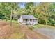 Charming cottage-style home featuring a screened front porch and a lush, wooded lot at 4481 Mclain Cir, Acworth, GA 30101