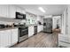 Well-equipped kitchen with stainless steel appliances, white cabinets, and ample countertop space for culinary adventures at 4481 Mclain Cir, Acworth, GA 30101