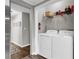 Convenient laundry room with modern washer and dryer units and functional shelving for easy organization at 4481 Mclain Cir, Acworth, GA 30101