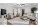 Inviting living room featuring hardwood floors, neutral tones, and comfortable seating with an open view to the entryway at 4481 Mclain Cir, Acworth, GA 30101