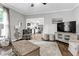 Bright living room with hardwood floors, neutral decor, and an open view of the kitchen at 4481 Mclain Cir, Acworth, GA 30101