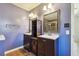 Traditional bathroom featuring dual sinks, wood cabinets, framed mirrors, and shower at 1108 Gwens Sw Trl, Lilburn, GA 30047