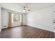 Empty bedroom with ceiling fan, laminate floors and a view of the woods at 1108 Gwens Sw Trl, Lilburn, GA 30047
