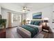 Bright bedroom with a large window, ceiling fan, and neutral decor at 1108 Gwens Sw Trl, Lilburn, GA 30047