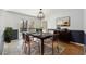 Formal dining area with modern lighting, deck access, and stylish decor at 1108 Gwens Sw Trl, Lilburn, GA 30047