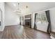 Spacious living room with cathedral ceiling, fireplace, modern light fixture, and ample natural light at 1108 Gwens Sw Trl, Lilburn, GA 30047