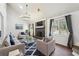 Spacious living room with cathedral ceiling, fireplace, modern light fixture, and ample natural light at 1108 Gwens Sw Trl, Lilburn, GA 30047