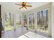Bright sunroom with abundant windows offering serene views of the surrounding trees at 1108 Gwens Sw Trl, Lilburn, GA 30047