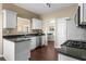 Galley kitchen features white cabinets, stainless steel appliances, and granite countertops at 3102 Ballet Se Ct, Smyrna, GA 30082